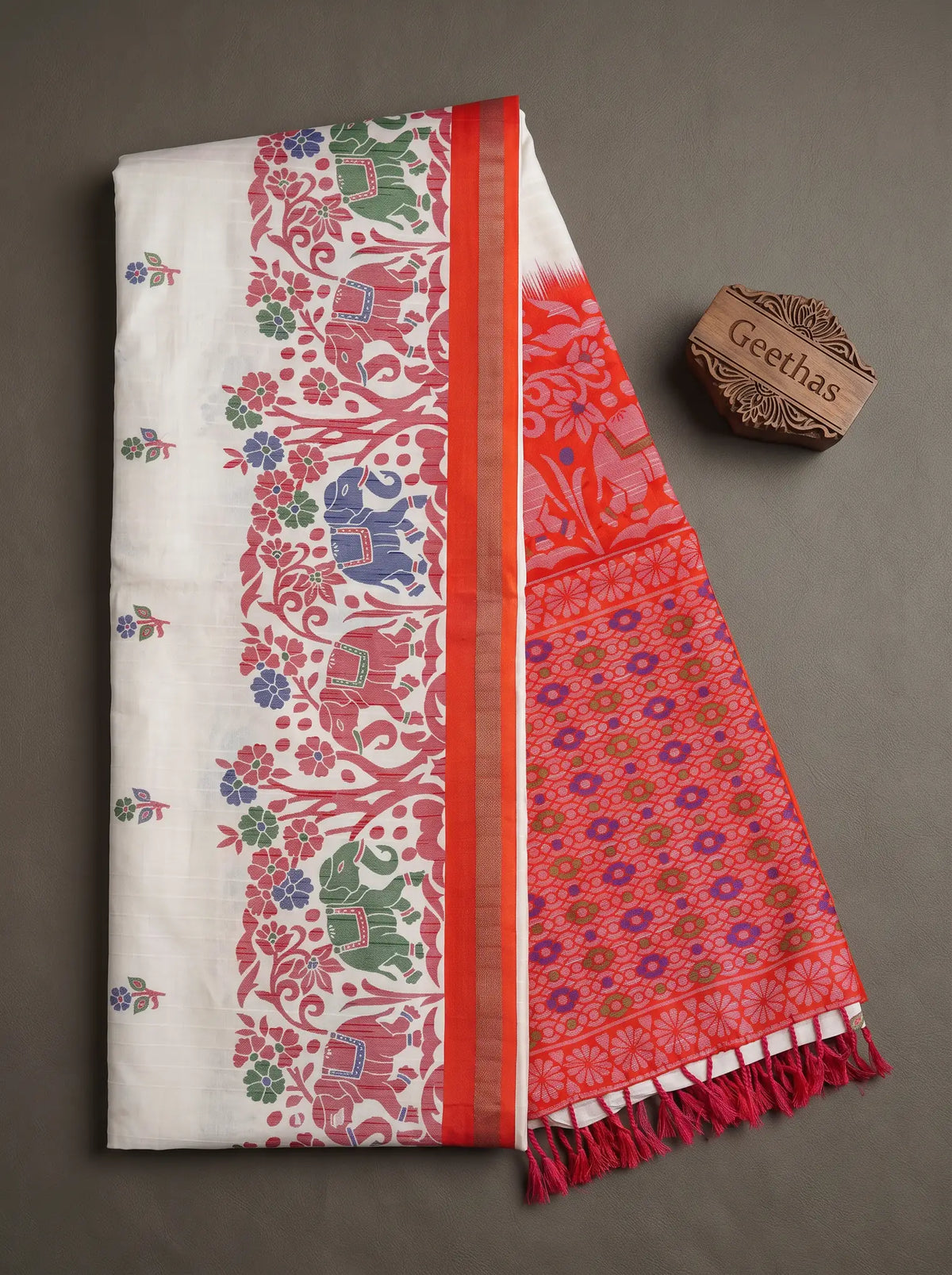 White slub linen saree with red floral and elephant print border, printed pallu and tasselled edge