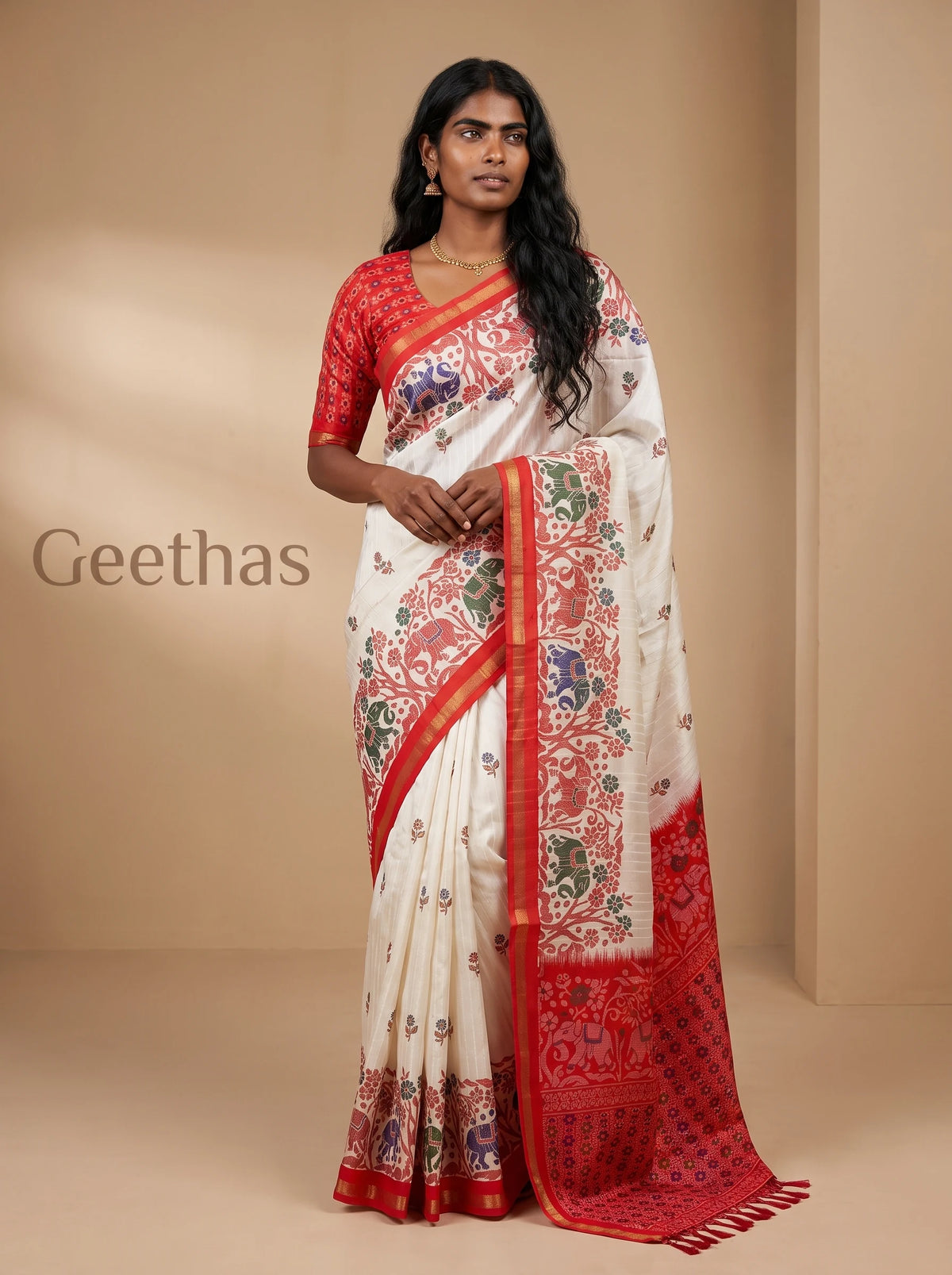 Model wearing a white and red printed slub linen saree with floral and elephant motifs and tasselled pallu