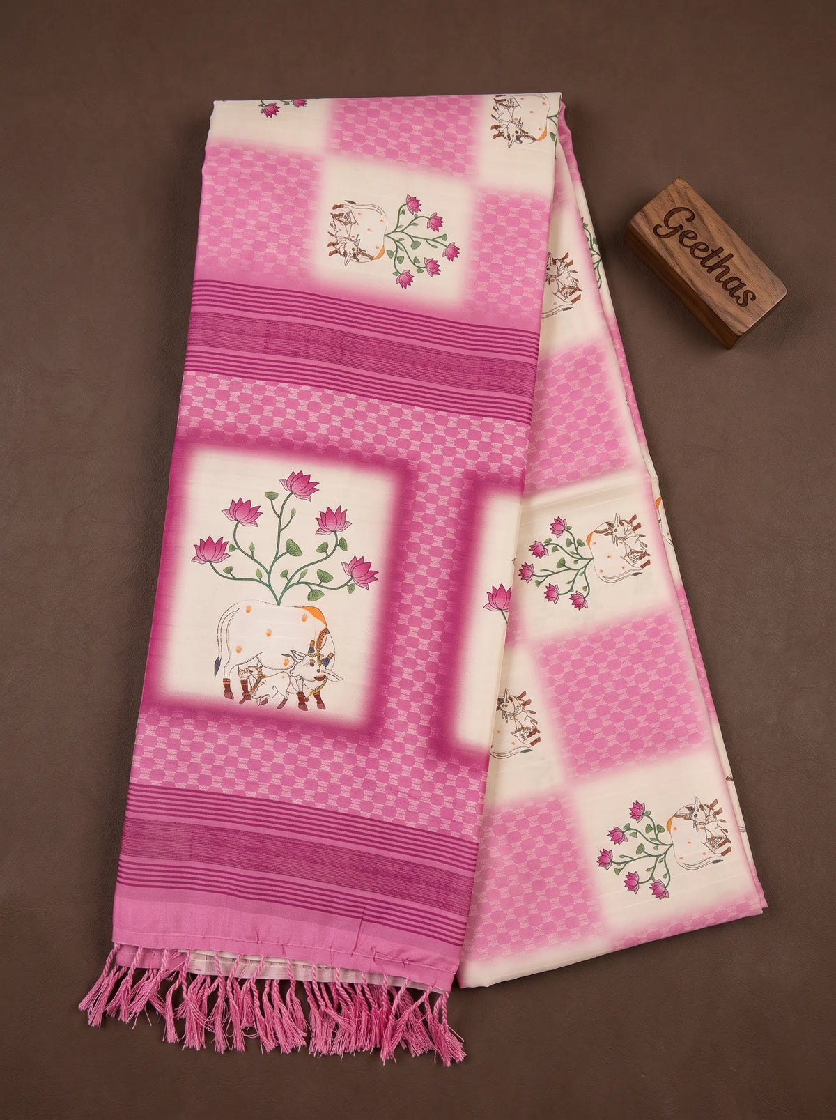 White and pink slub linen saree with lotus floral and traditional cow motif print, striped border and tasselled pallu