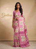 Model wearing a white and pink slub linen saree with lotus floral and traditional cow motif print