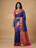 Model wearing a royal blue semi silk saree with pink and gold-toned woven border and pallu