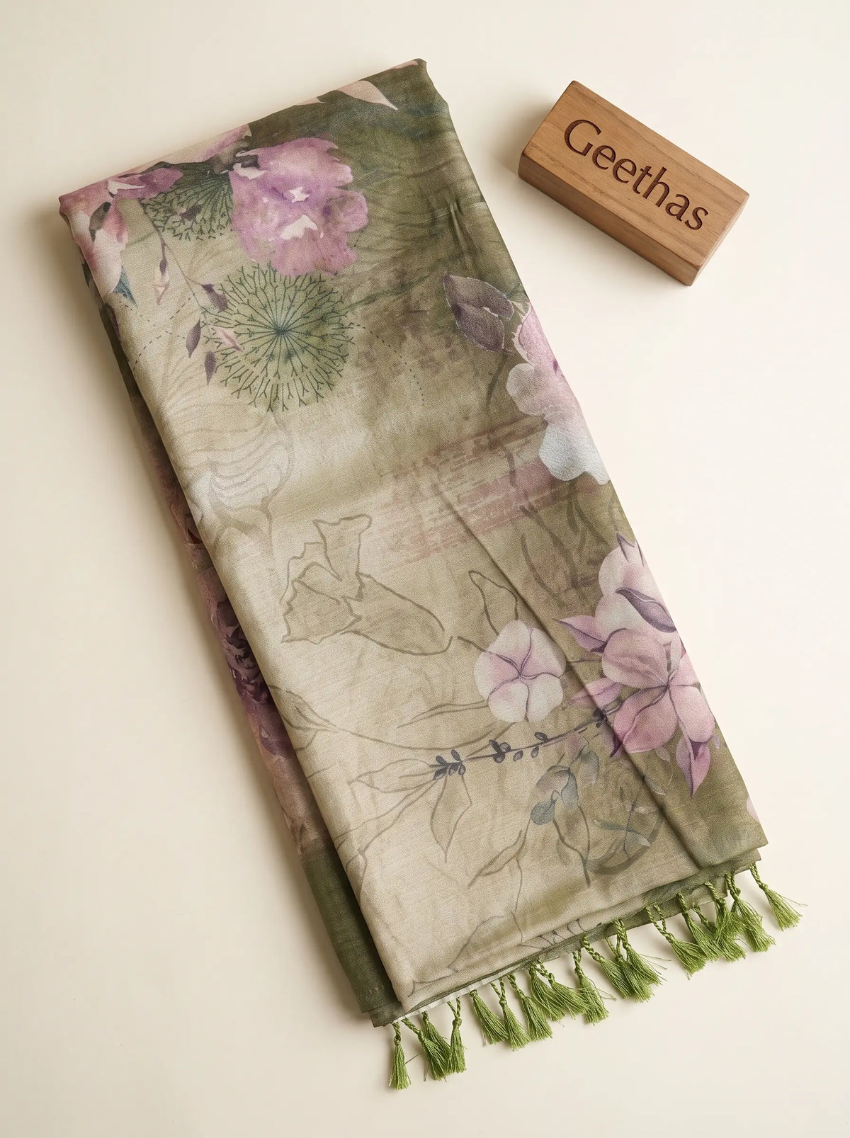 Folded olive green semi tussar saree with pink floral print and green tassel detailing