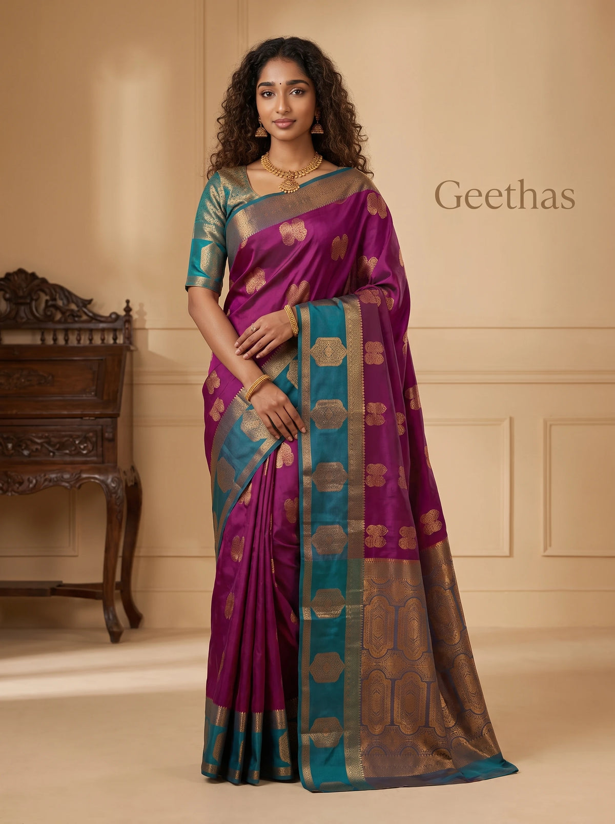 Model wearing a magenta pink soft silk saree with gold-toned woven motifs, teal border and ornate pallu