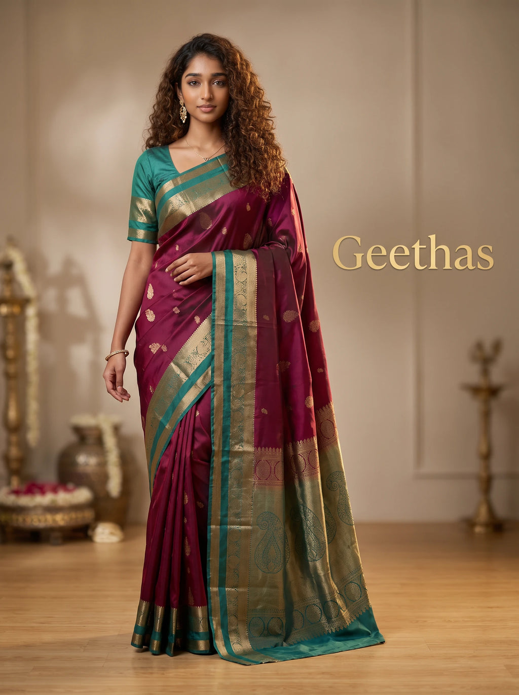 Model wearing magenta soft silk saree with teal and gold-toned woven border and paisley pallu