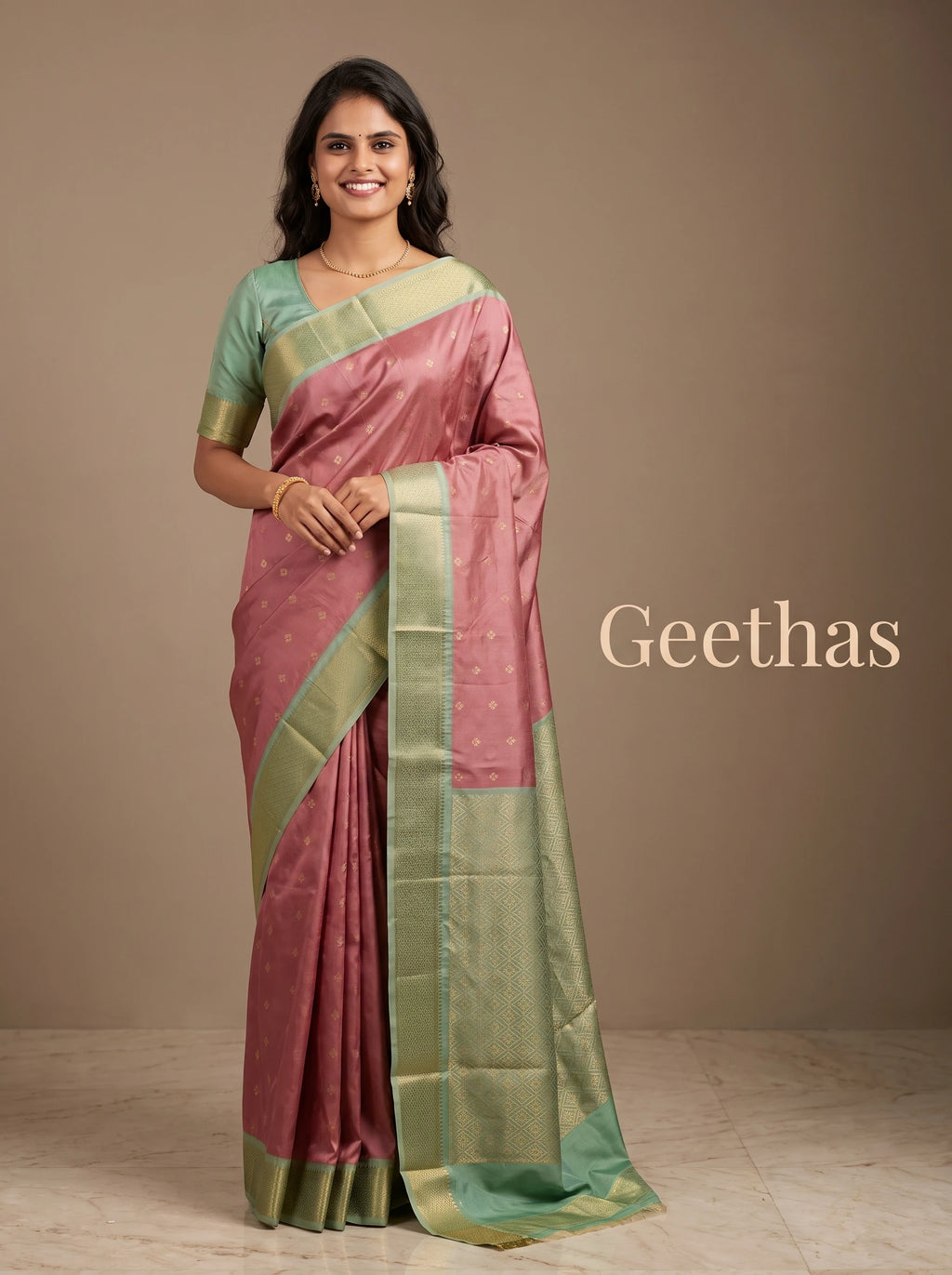 Model wearing an onion pink soft silk saree with gold-toned motifs and a sea green woven border
