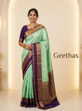 Model wearing a mint green soft silk saree with gold-toned woven motifs and a deep purple decorative border.