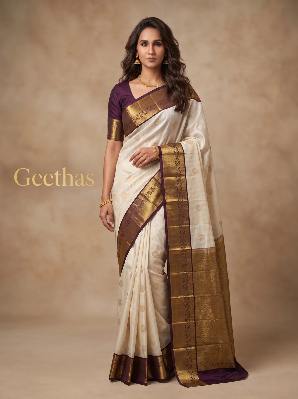 Model wearing a half white soft silk saree with gold-toned woven motifs and brown border