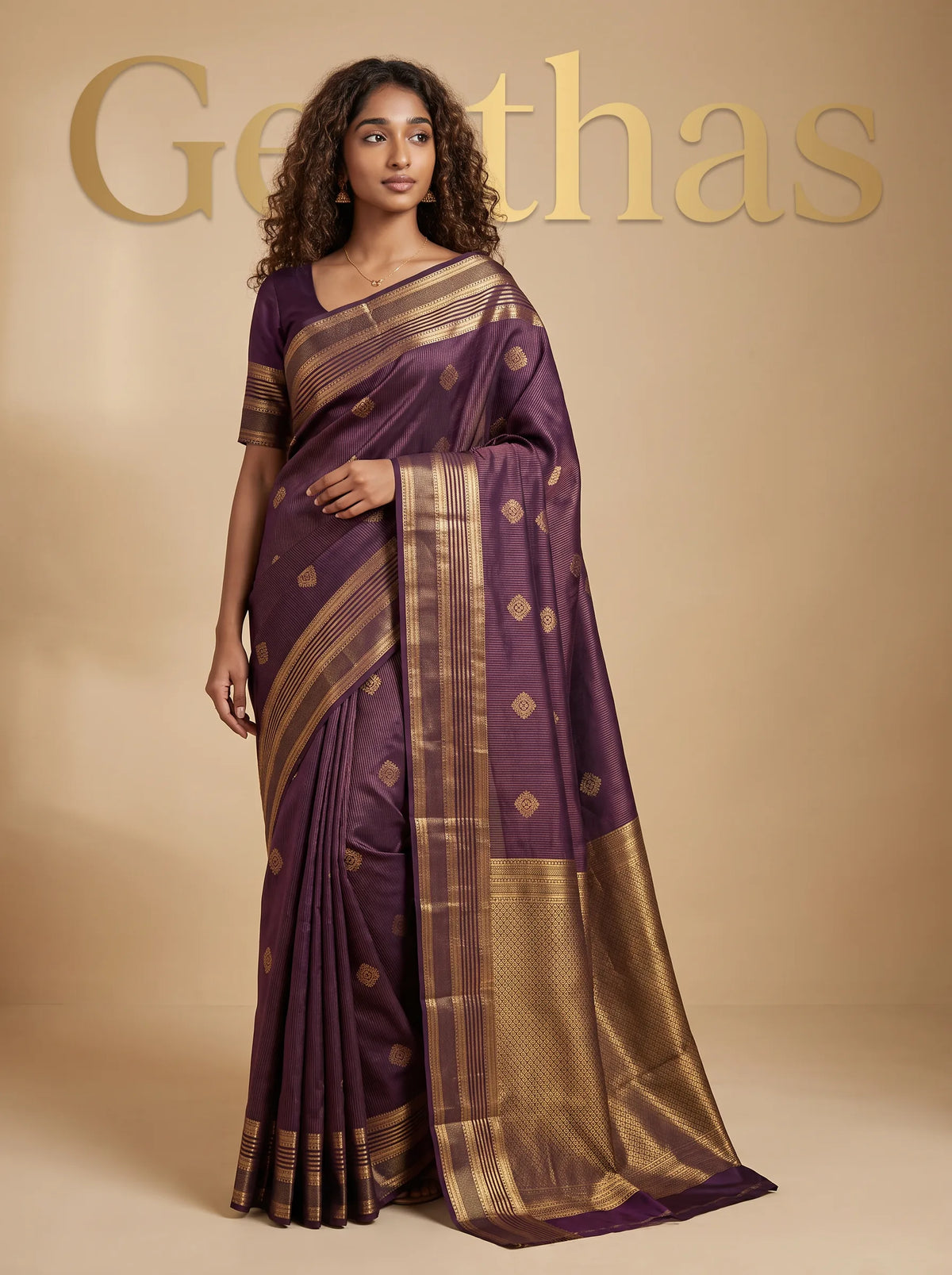 Model wearing a dark purple soft silk saree with gold-toned woven motifs, patterned border and geometric pallu