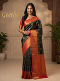 Model wearing a forest green soft silk saree with gold-toned woven motifs and red decorative border