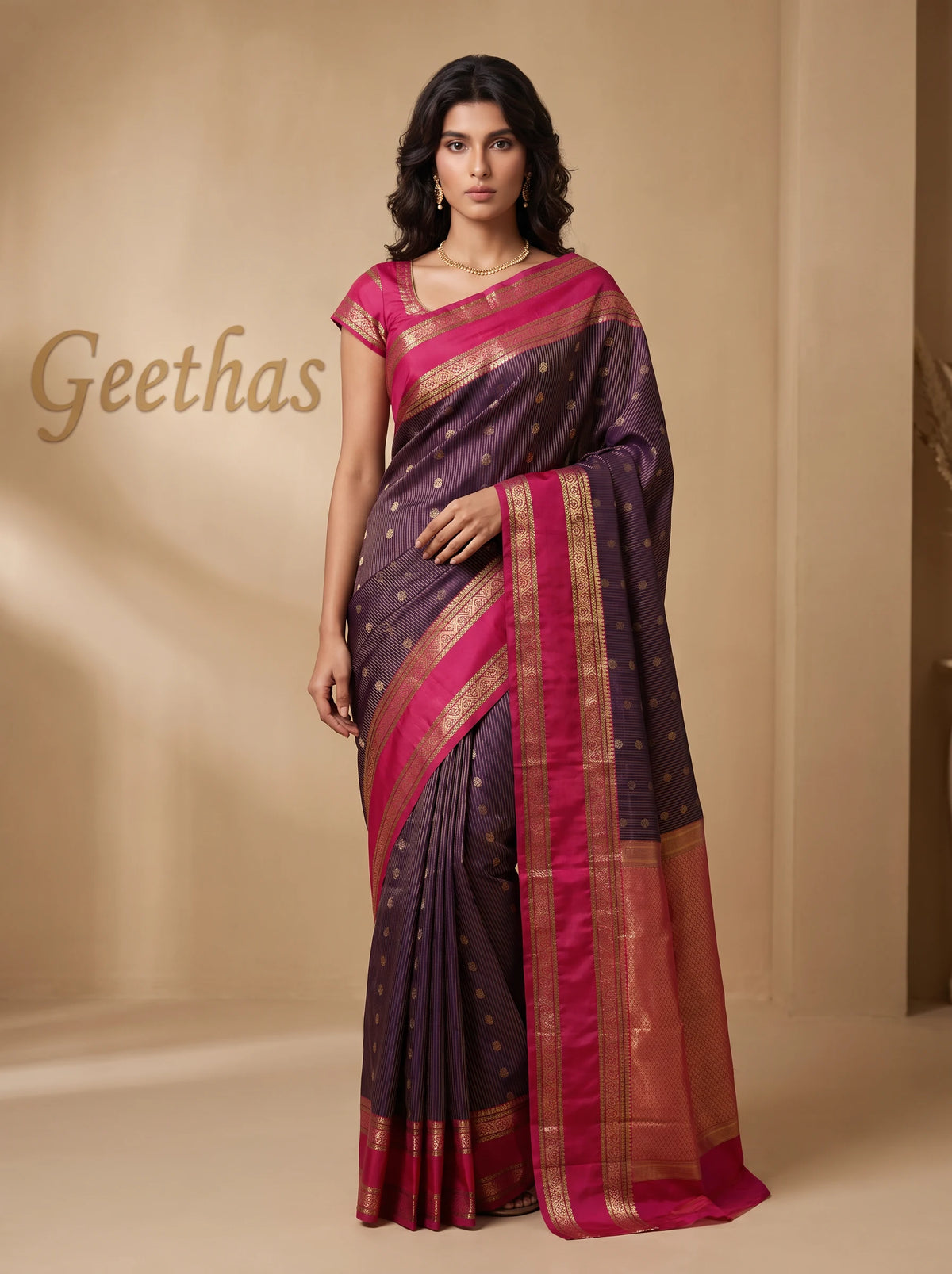 Model wearing a deep purple soft silk saree with fine gold-toned floral motifs and a rose-pink woven border.