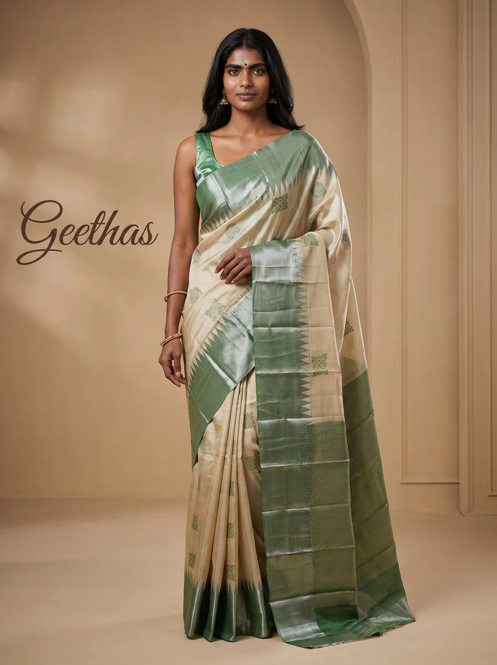 Model wearing beige tissue soft silk saree with green woven border and geometric pallu