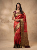 Model wearing a burnt orange soft silk saree with gold-toned zari paisley motifs and a wide ornate border